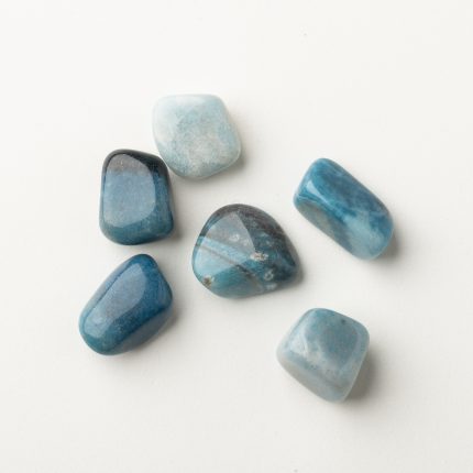 Blaue Heilsteine für Energiearbeit und spirituelle Balance auf weißem Hintergrund. Perfekt für Meditation und Heilung.